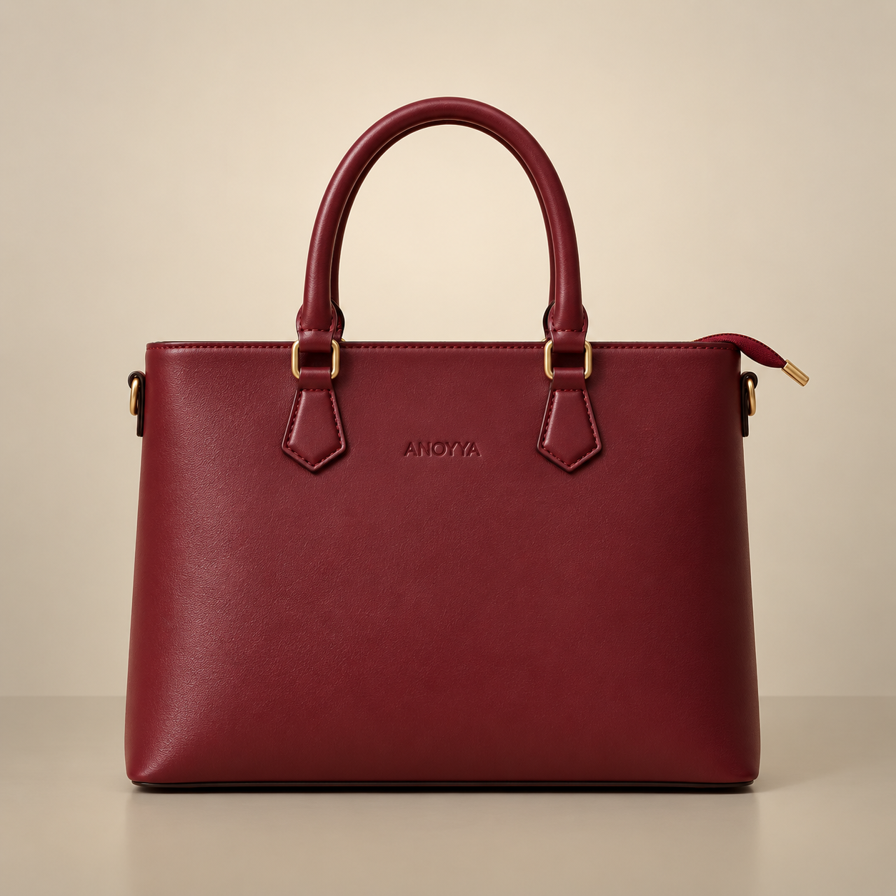 Front view of the ANOVYA burgundy luxury tote bag on a beige studio background