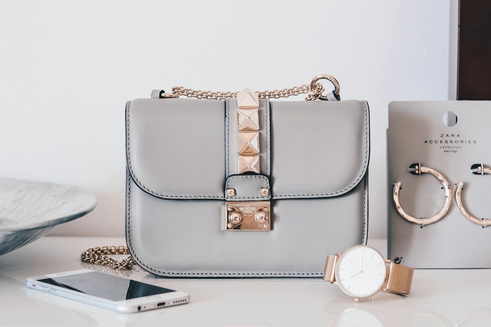 Grey handbag photographed in a clean editorial fashion setting